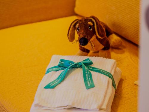 a stuffed dog sitting next to a roll of toilet paper at La Maison de la Mer with Terrace and AC in Vernazza