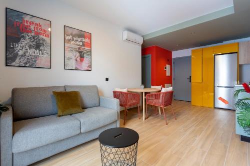 a living room with a couch and a table at Sholeo Lodges Las Palmas Flats in Las Palmas de Gran Canaria