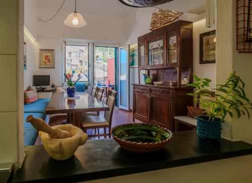 a kitchen with a table and a dining room at La Maison de la Mer with Terrace and AC in Vernazza