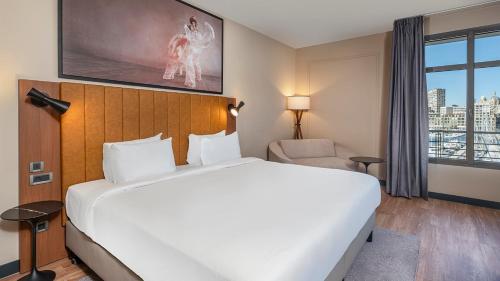 a hotel room with a large bed and a window at Radisson Blu Hotel Marseille Vieux Port in Marseille