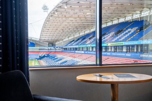 a view of an empty stadium from a table at The Bolton Stadium Hotel, a member of Radisson Individuals in Bolton
