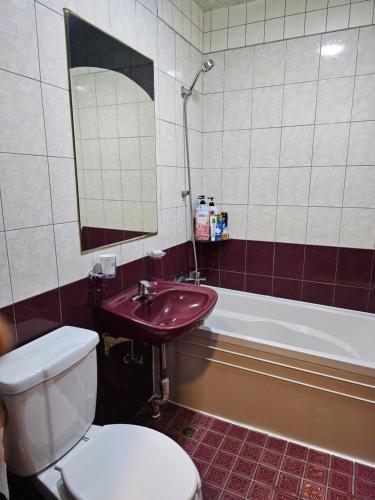 a bathroom with a toilet and a sink and a tub at Mirim Motel in Gyeongju