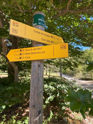 a sign on a wooden pole with signs on it at Lou Souleu in Sisteron
