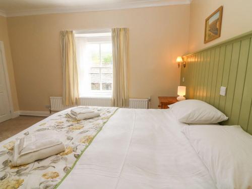 a bedroom with a large white bed with a window at Kearton Shunner Fell in Richmond