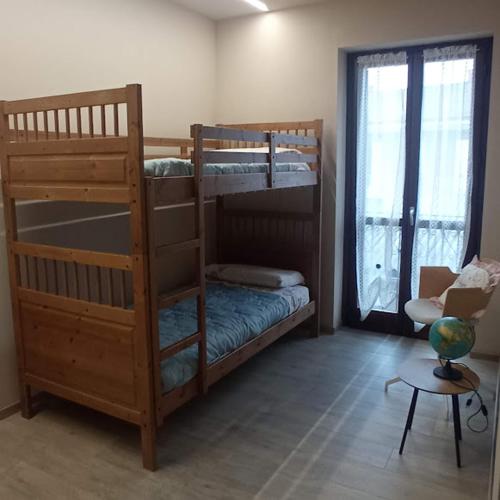 a room with two bunk beds and a table at Casa Martina in Canale