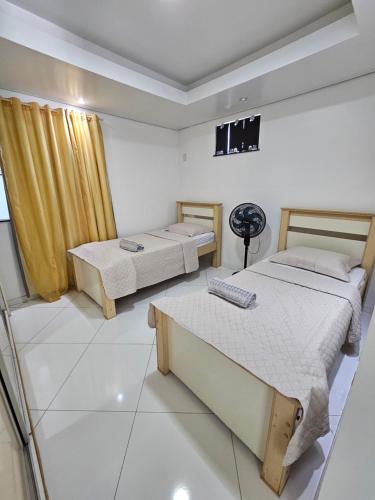 a bedroom with two beds and a keyboard in it at Apartamentos - Repouso do Guerreiro in Itabuna