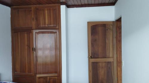 two wooden cabinets in a room with a wall at Cerca a Parque Nariño in Pasto