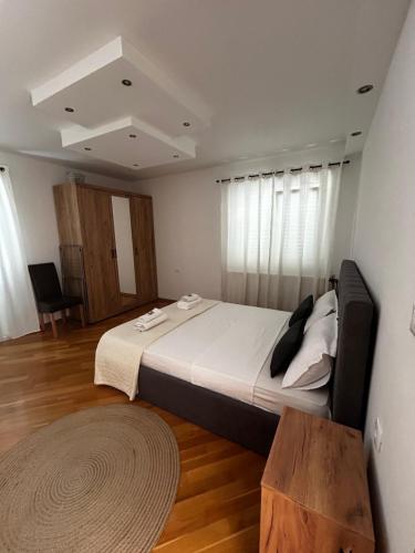 a bedroom with a large bed and a wooden floor at Apartman Marija in Korčula