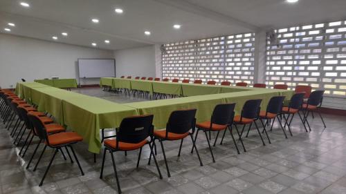 a large conference room with a long table and chairs at Imca Hotel in Buga