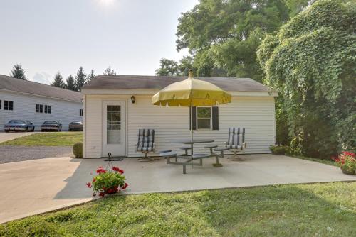 a patio with a table and chairs and an umbrella at Cozy Lakemont Getaway, 11 Mi to Watkins Glen! in Lakemont