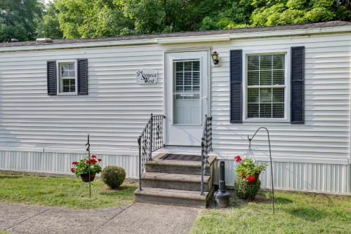 a white house with stairs and a door at Cozy Lakemont Getaway, 11 Mi to Watkins Glen! in Lakemont