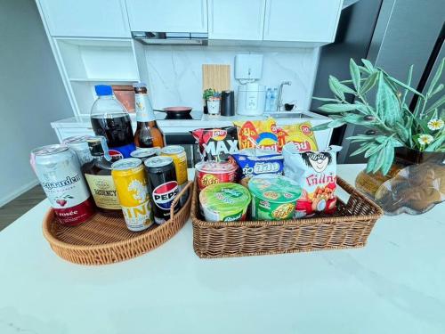 two baskets filled with snacks and drinks on a counter at Gaia Pool Villa Khao Yai in Ban Bung Toei