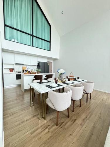 a dining room with a table and chairs at Gaia Pool Villa Khao Yai in Ban Bung Toei