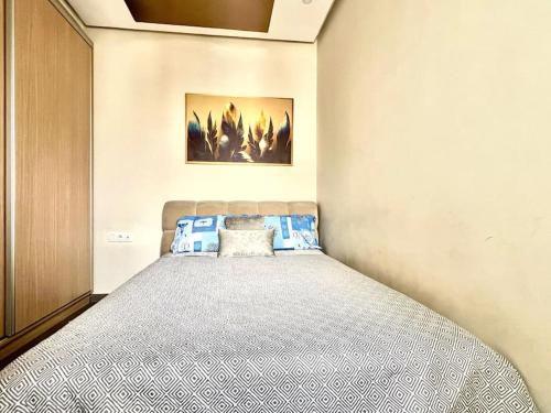a bedroom with a large bed in a room at Appartement HAY SALAM Agadir in Agadir