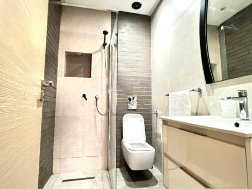 a bathroom with a toilet and a sink and a shower at Appartement HAY SALAM Agadir in Agadir