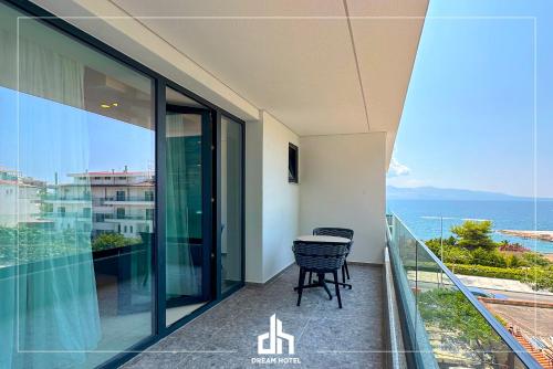 a balcony with a table and a view of the ocean at DREAM HOTEL SARANDA in Sarandë