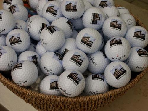 a basket full of baseball balls on a table at Golf Club Metaponto in Metaponto