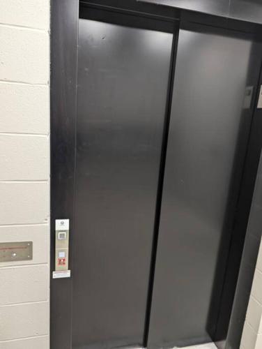 a glass elevator door in a building with at Clay St Suite in Millersburg