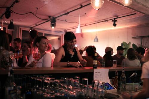 a group of people sitting at a bar at Story Thusis in Thusis