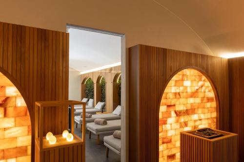 a living room with arched windows and a fireplace at Borgo Dei Conti Resort Relais & Chateaux in Monte Petriolo