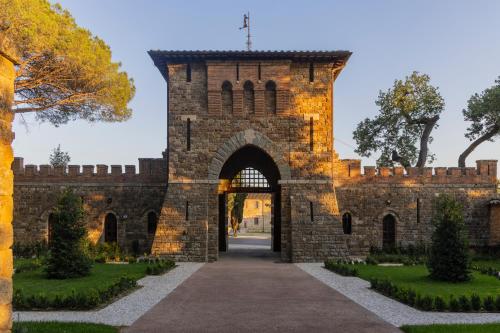 an entrance to a brick building with an archway at Borgo Dei Conti Resort Relais & Chateaux in Monte Petriolo