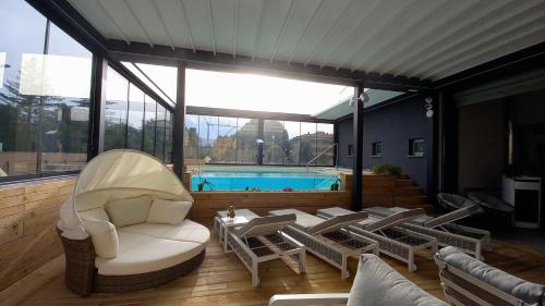 a patio with chairs and a swimming pool at Hotel Giardino in Bibbiena