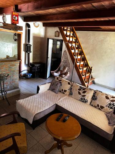 a living room with a couch and a staircase at Holiday Home Nikolić in Njeguši