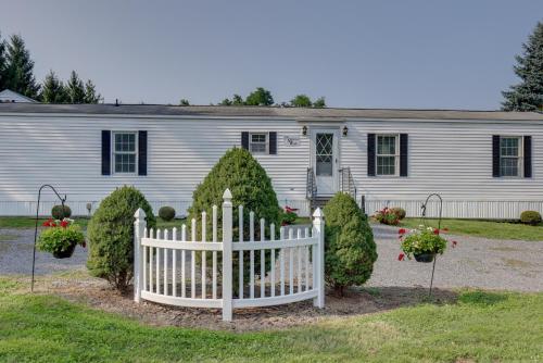 a white fence in front of a house at Quaint Lakemont Retreat 1 Mi to Seneca Lake! in Lakemont