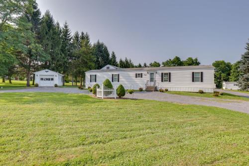 a white farm house with a large yard at Quaint Lakemont Retreat 1 Mi to Seneca Lake! in Lakemont