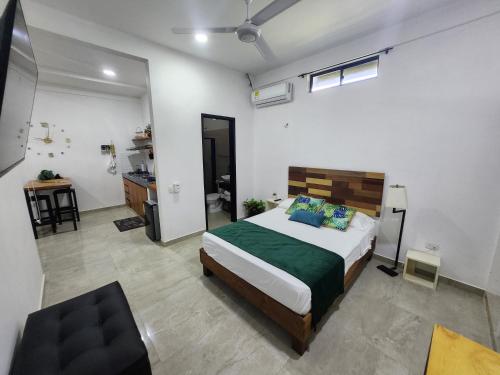 a bedroom with a bed and a desk in it at Amazonia Deluxe Calle 13 in Leticia