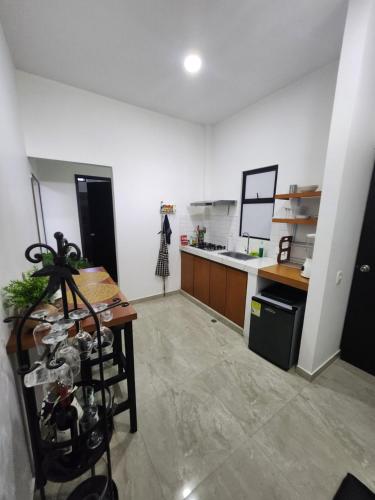 a kitchen with a table and a counter top at Amazonia Deluxe Calle 13 in Leticia