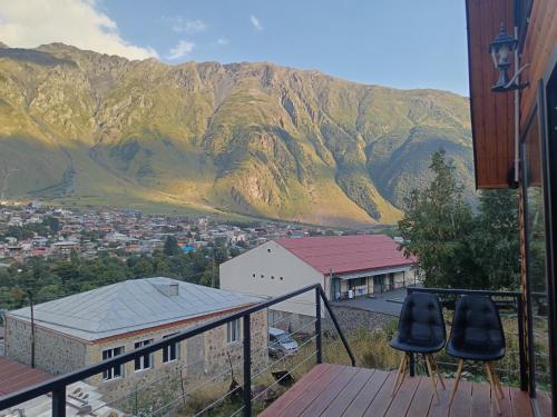 a view of a mountain from the balcony of a house at My house in Stepantsminda