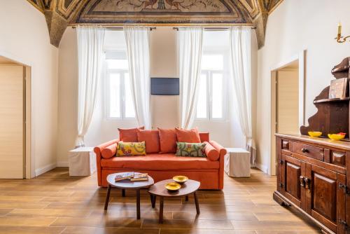 a living room with a couch and a table at Pantheon Apartments - Piccola Roma in Rome