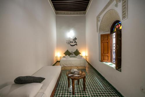a living room with a couch and a table at Riad Nashira in Fès