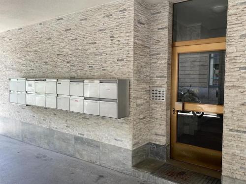 a brick wall with a row of cabinets next to a door at Very central and sunny 2BR flat - Marble 2 in Zürich