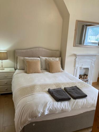 a bedroom with a bed with two towels on it at Maurice House 3 bedroom self catering townhouse in Bangor