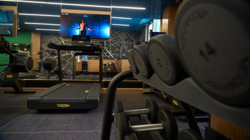 a gym with a tv and some weights at Holiday Inn Tashkent City by IHG in Tashkent