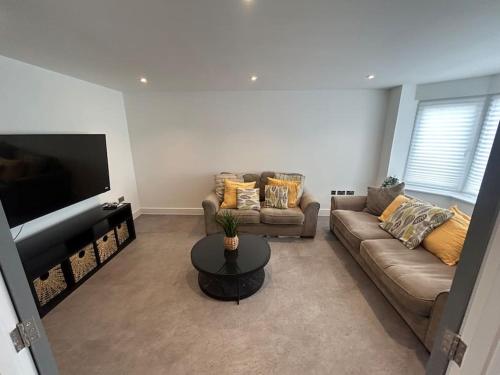 a living room with a couch and a table at Luxury 4 bedroom house in Bristol