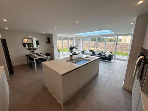 a large living room with a couch and a table at Luxury 4 bedroom house in Bristol