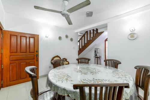 a dining room with a table and chairs at Villa Wedamulla in Unawatuna