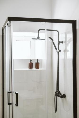 a shower stall with a glass door with two bottles at Magec Villa de Arico in Lomo de Arico