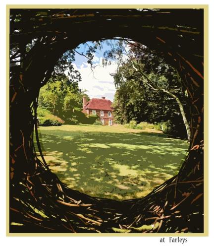 a picture of a house through a tree archway at The Guest Suite, Buttsfield Lane. in East Hoathly