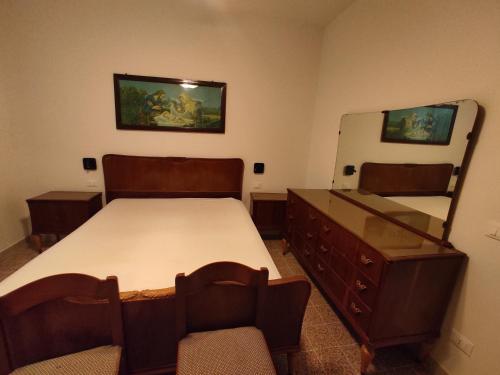 a bedroom with a bed and a dresser and a mirror at Lunamora 2 in Rodi Garganico