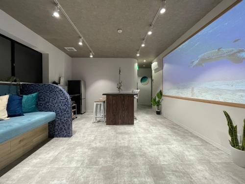 a room with a large window with a large aquarium at Marin Base ONAHAMA in Iwaki