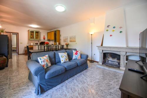 a living room with a blue couch and a fireplace at Afonso's House Gerês I in Braga