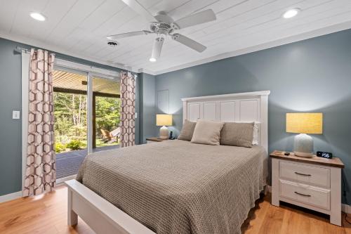 a bedroom with a bed and a window at Belleau Lake Escape in Wakefield