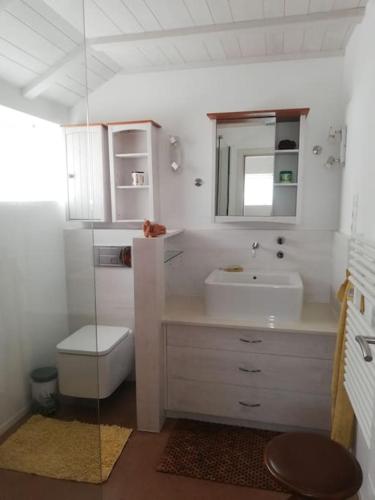 a white bathroom with a sink and a toilet at Ferienhaus Finca Sonrisa in Puntagorda