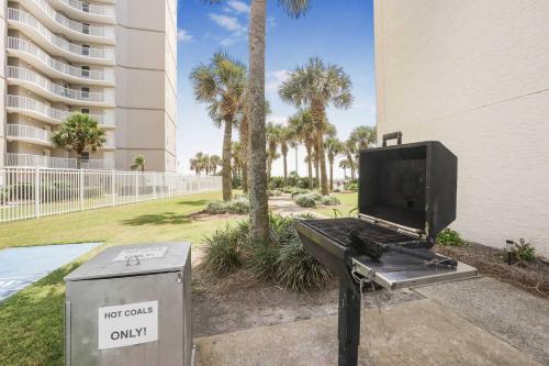 a grill with a tv on it next to a building at Seaside Beach 2103- Ground level beachside in Orange Beach