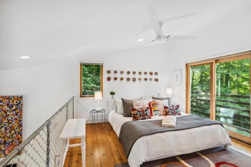 a bedroom with two beds and a balcony at The Mod Lodge in Boone