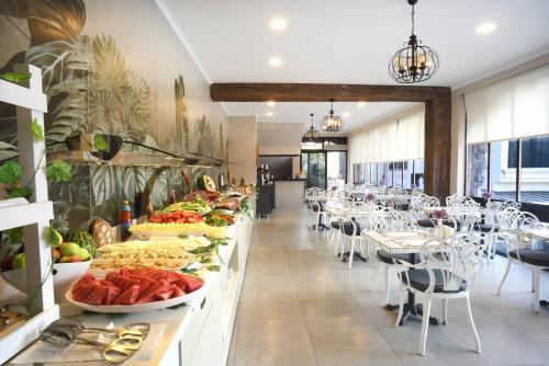 a buffet line with plates of food in a restaurant at AMOSSİA Elite Boutique Hotel in Turunc